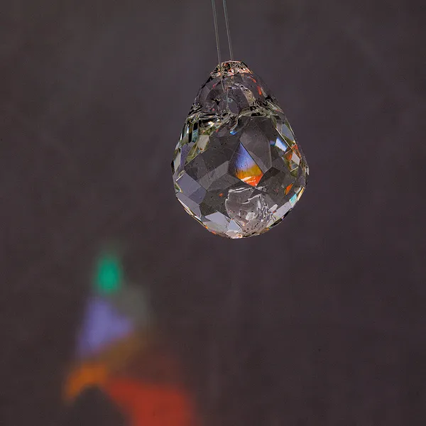 Glass teardrop pendant with intense color refraction