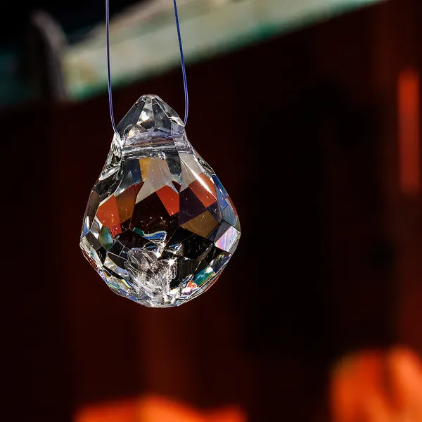 Faceted glass teardrop pendant hanging indoors