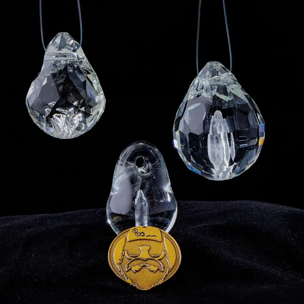 Group of glass memorial pendants with gold signature coin