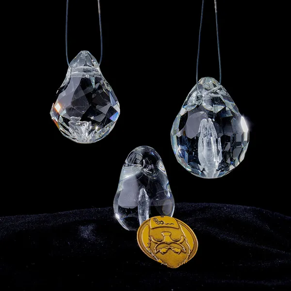 Group of glass memorial pendants with gold signature coin