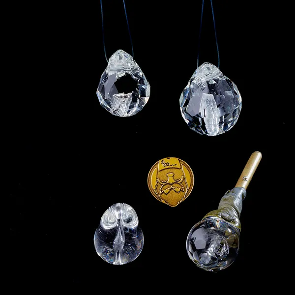 Group of glass memorial pendants with gold signature coin